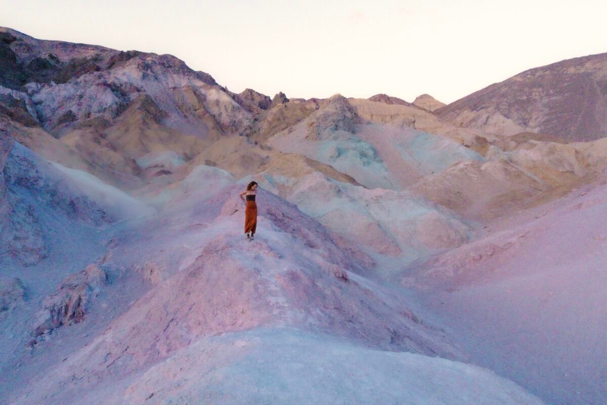 Woman standing at Artists Pallete in Death Valley NP for sunset