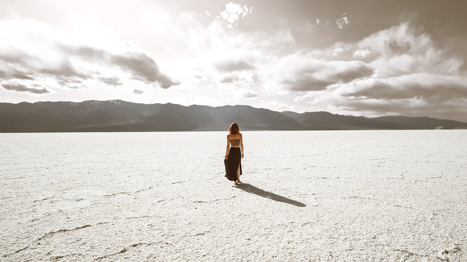 Woman standing on the Badwater Basin salt flats in Death Valley NP
