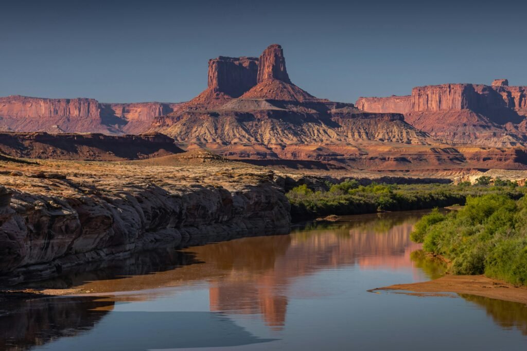 Stunning view of Utah's Canyonlands National Park with the Colorado River at sunrise.
