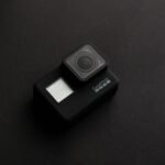 High-quality image of a GoPro camera on a dark surface, ideal for tech content.