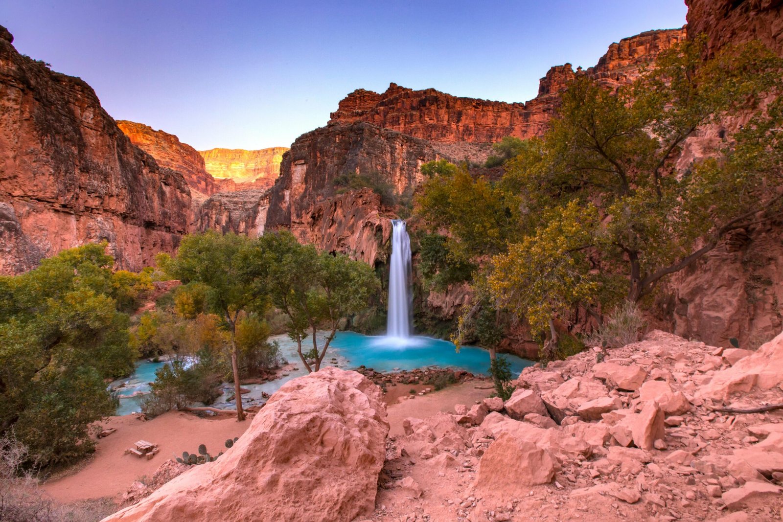 Havasu Falls cascades into a turquoise pool in Arizona's Grand Canyon.