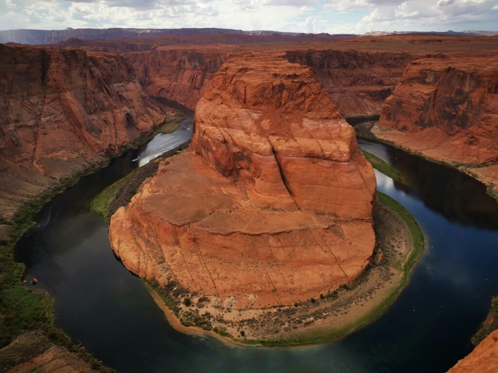 A breathtaking aerial view of Horseshoe Bend revealing its iconic curved canyon and the Colorado River.
