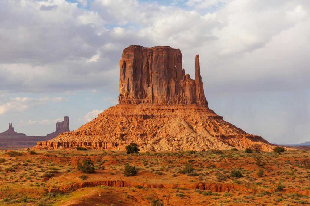 Monument Valley's iconic buttes in Moab, Utah, captured under a clear sky, showcasing stunning natural rock formations.