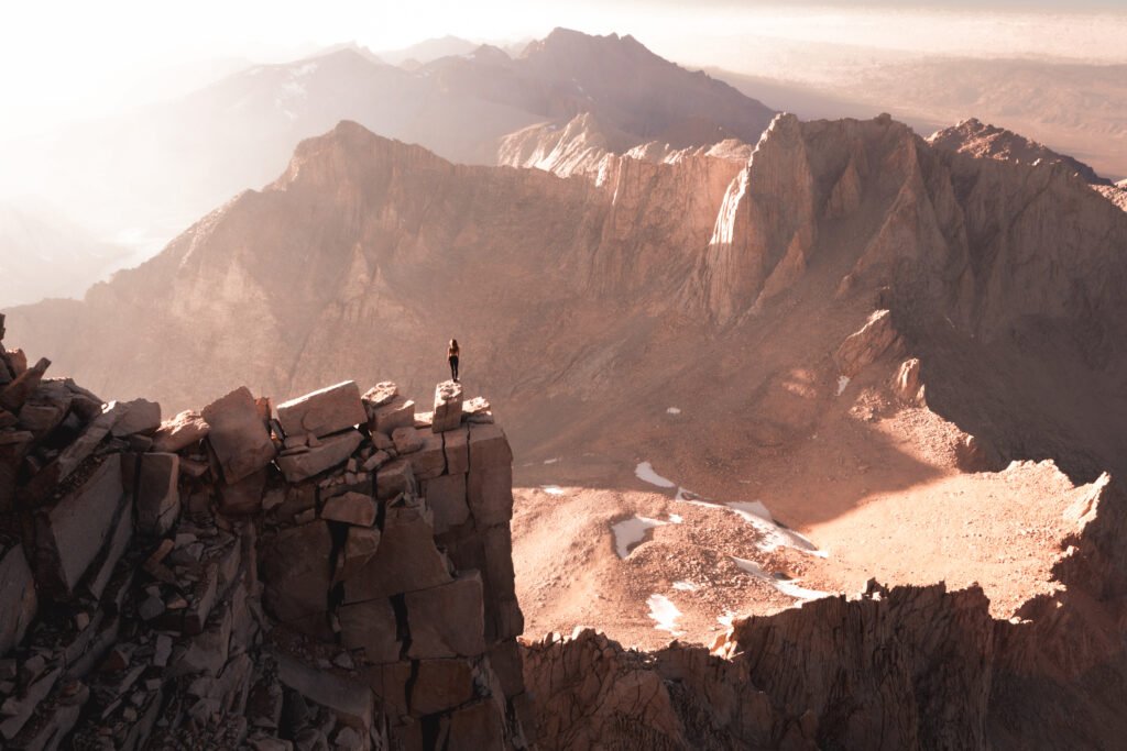A photo of Chelsea at the summit of Mount Whitney, in a blog about the best 3 off-trail hikes