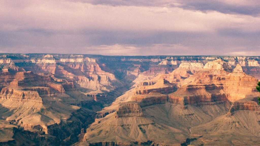 pexels-photo-154140-154140 Breathtaking panoramic view of the Grand Canyon under a vibrant, cloudy sky.