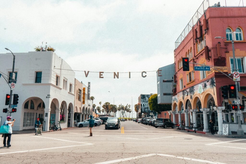 pexels-photo-2763964-2763964 Street view of Venice Beach in Los Angeles, California featuring colorful buildings and lively atmosphere.