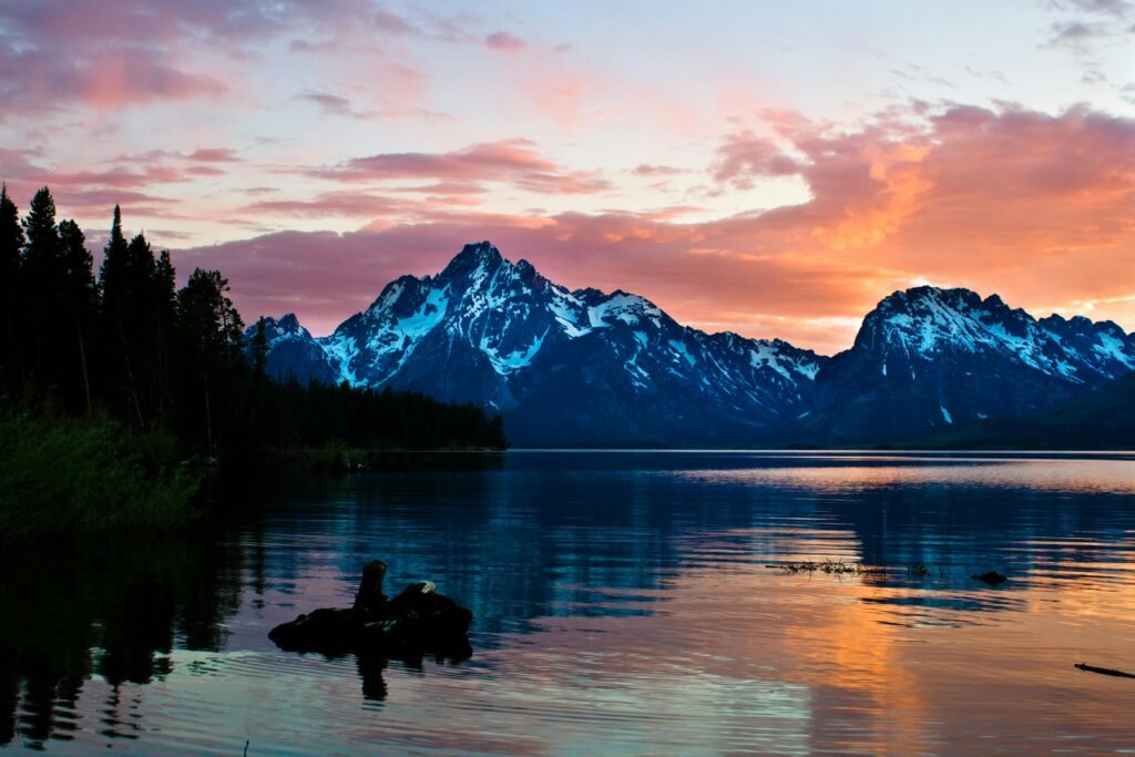pexels-photo-833779-833779 Breathtaking sunrise over Jenny Lake with snow-capped mountains and serene waters reflecting the vibrant sky.
