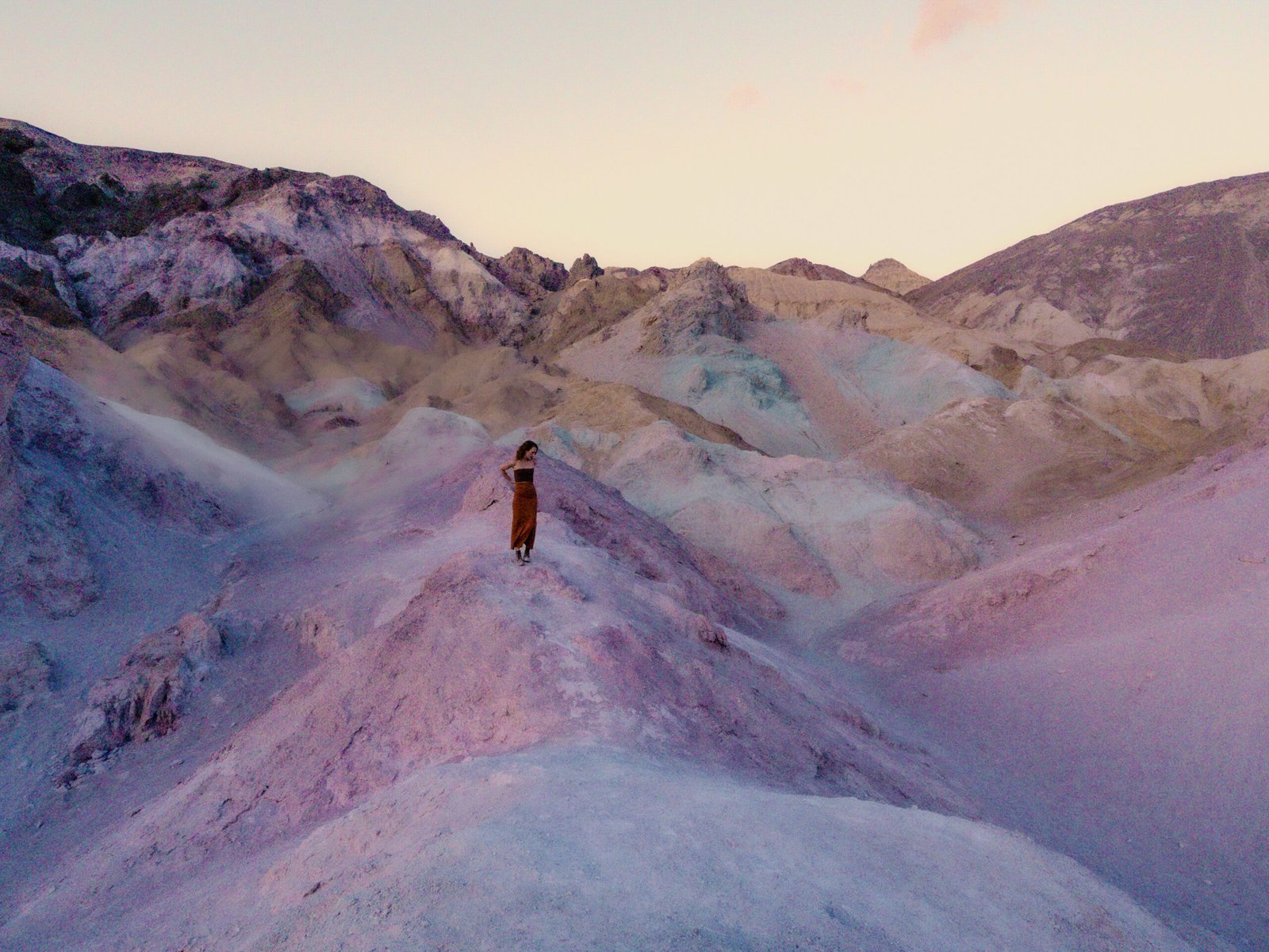 Woman standing in Artists Palette for sunset in Death Valley National Park